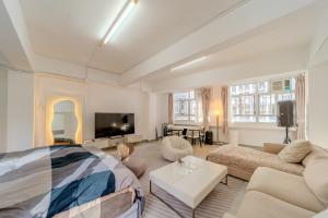 a large living room with a bed and a couch at Huge Studio and Rooftop in Central in Hong Kong