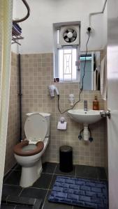 a bathroom with a toilet and a sink at Huge Studio and Rooftop in Central in Hong Kong +5 photos