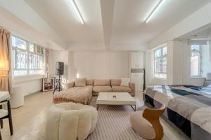 a large room with a bed and a couch at Huge Studio and Rooftop in Central in Hong Kong