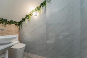 a bathroom with a toilet and a glass shower at The Viewpoint by Eurostay in Ribeira Brava +13 photos