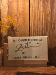 a sign sitting on top of a wooden table at Ferienhaus Gruber in Aich