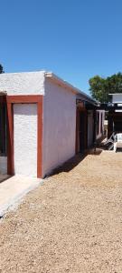 a white building with a door on the side of it at Terrazas al Sol 03 in Playa Hermosa