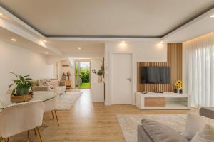 a living room with a couch and a tv at The Viewpoint by Eurostay in Ribeira Brava