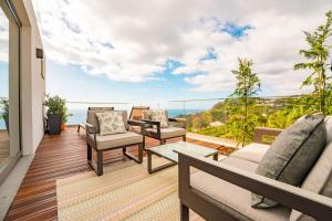 a balcony with furniture and a view of the ocean at The Viewpoint by Eurostay in Ribeira Brava