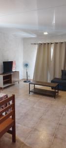 a living room with a couch and a table at Terrazas al Sol 03 in Playa Hermosa