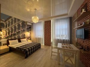 a bedroom with a bed and a table and a desk at Апартаменти Площа Ринок in Lviv