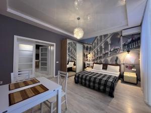 a bedroom with a bed and a desk in it at Апартаменти Площа Ринок in Lviv +4 photos