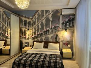 a bedroom with a bed and a wall with flowers at Апартаменти Площа Ринок in Lviv