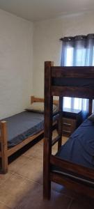 a bedroom with two bunk beds and a window at Terrazas al Sol 03 in Playa Hermosa