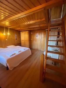 a bedroom with a bed and a wooden ceiling at L'Auberge de la Combal in La Comballaz