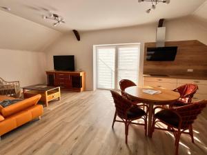 a living room with a table and a couch at Seeidyll Potzlower See in Potzlow