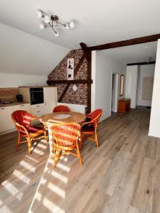 a kitchen and dining room with a table and chairs at Seeidyll Potzlower See in Potzlow