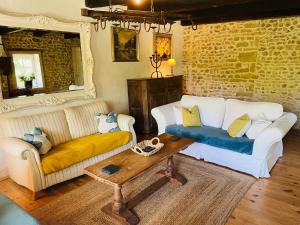 a living room with a couch and a table at Le Reve de Breuillac in Surin +47 photos