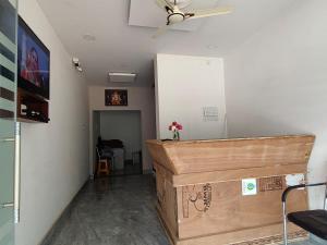 a room with a ceiling fan and a large box at Swastiik Inn in Belpahār +4 photos