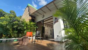 a house with a patio with orange chairs on a porch at Hato San Pablo in Guayabal