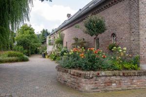 een bakstenen gebouw met bloemen in een bakstenen muur bij B&B Reveille in Kleve