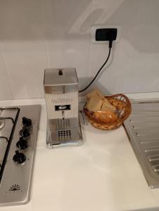 a kitchen counter with a toaster and a basket of bread at Casa Vacanze Giano in Antrodoco +18 photos