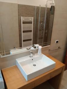 a bathroom with a white sink and a mirror at Casa Vacanze Giano in Antrodoco