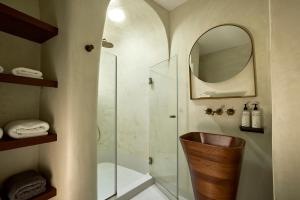 a bathroom with a shower and a sink and a mirror at Hotel Adonis in Mikonos +189 photos