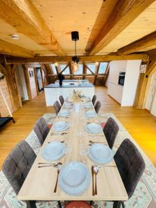 a long wooden table in a room with chairs at Schwarzwald Mauer Loft in Bräunlingen +37 photos