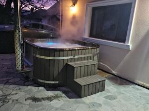 a jacuzzi tub with stairs in front of a building at Casa Hera in Călimăneşti +52 photos