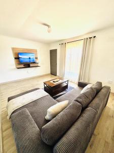 a living room with a couch and a flat screen tv at Small town comfort in Marquard