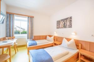 a hotel room with two beds and a table at Apartment Mauser-Mühltaler in Mauterndorf +71 photos