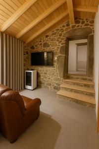 un soggiorno con un divano e una TV di Uíma River House 