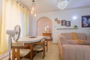 a living room with a couch and a table at SeyniKe 2BR Apartment - Nyali - AC, WiFi - Parking in Mombasa