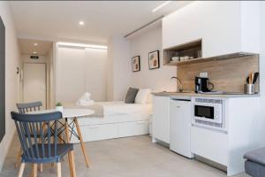 a kitchen with a bed and a table in a room at Genesis-Loft San Enrique 14 in Madrid