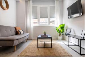 a living room with a couch and a table at Genesis-Loft San Enrique 14 in Madrid