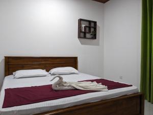 a bedroom with a bed with a swan on it at Villa 505 Induruwa in Induruwa