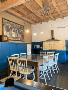 una cucina con tavolo e sedie in legno di Grote Goesting holiday house a Wevelgem