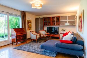 a living room with a couch and a piano at Private Pool Villa with Garden & Nature by Destination GREEN Croatia in Pregrada