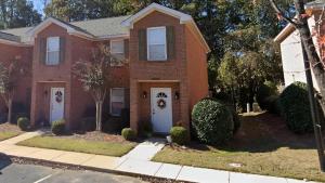 a red brick house with two white doors at Lovely 2BR 3BA Condo in Auburn