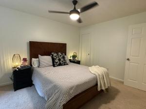 a bedroom with a bed with a ceiling fan at Lovely 2BR 3BA Condo in Auburn +9 photos