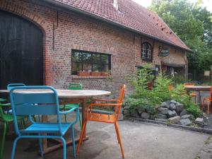un tavolo e sedie di fronte a un edificio in mattoni di Grote Goesting holiday house a Wevelgem