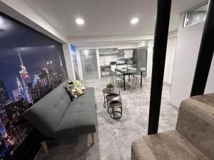 a living room with a couch and a dining room at Steps from the Historic Center & Malecón in Campeche