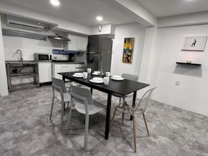 a kitchen with a dining room table and chairs at Steps from the Historic Center & Malecón in Campeche +2 photos