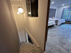 a living room with a staircase leading to a bedroom at Steps from the Historic Center & Malecón in Campeche