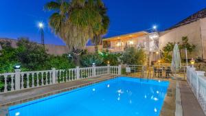a swimming pool in front of a house with a fence at Villa Neymar in Kaş