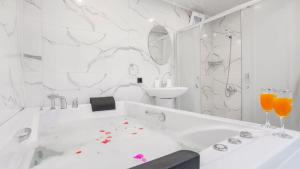 a white bathroom with a tub and a sink at Villa Neymar in Kaş +32 photos