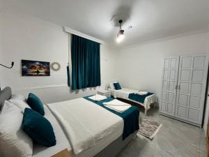 a bedroom with two beds and a couch in it at Villa Neymar in Kaş