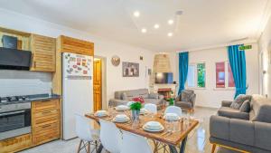 a kitchen and living room with a table and chairs at Villa Neymar in Kaş