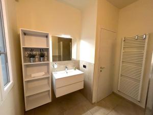 a bathroom with a sink and a mirror at Colombo Central Apartment in Garda +18 photos