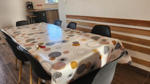 a table with a table cloth on it with chairs at Maison proche Futuroscope in Chasseneuil-du-Poitou