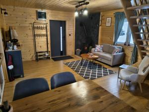 a living room with a couch and a table and chairs at Juraszówka in Kamesznica