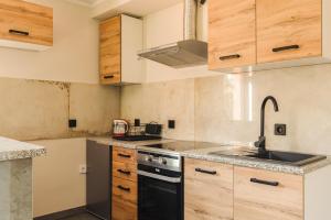 a kitchen with a sink and a stove top oven at Agroturystyka Monte Luna - Domki in Czarnów