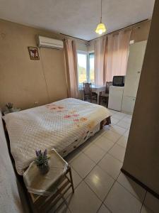 a bedroom with a bed and a table and chairs at Villa Lira in Pavel Banya