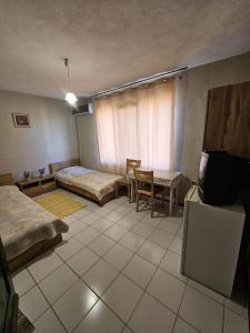 a room with two beds and a table in it at Villa Lira in Pavel Banya
